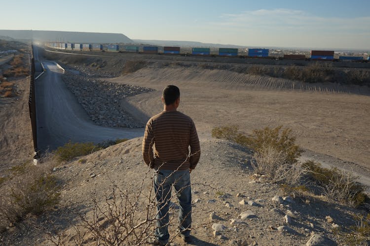 A Man Standing By The Border