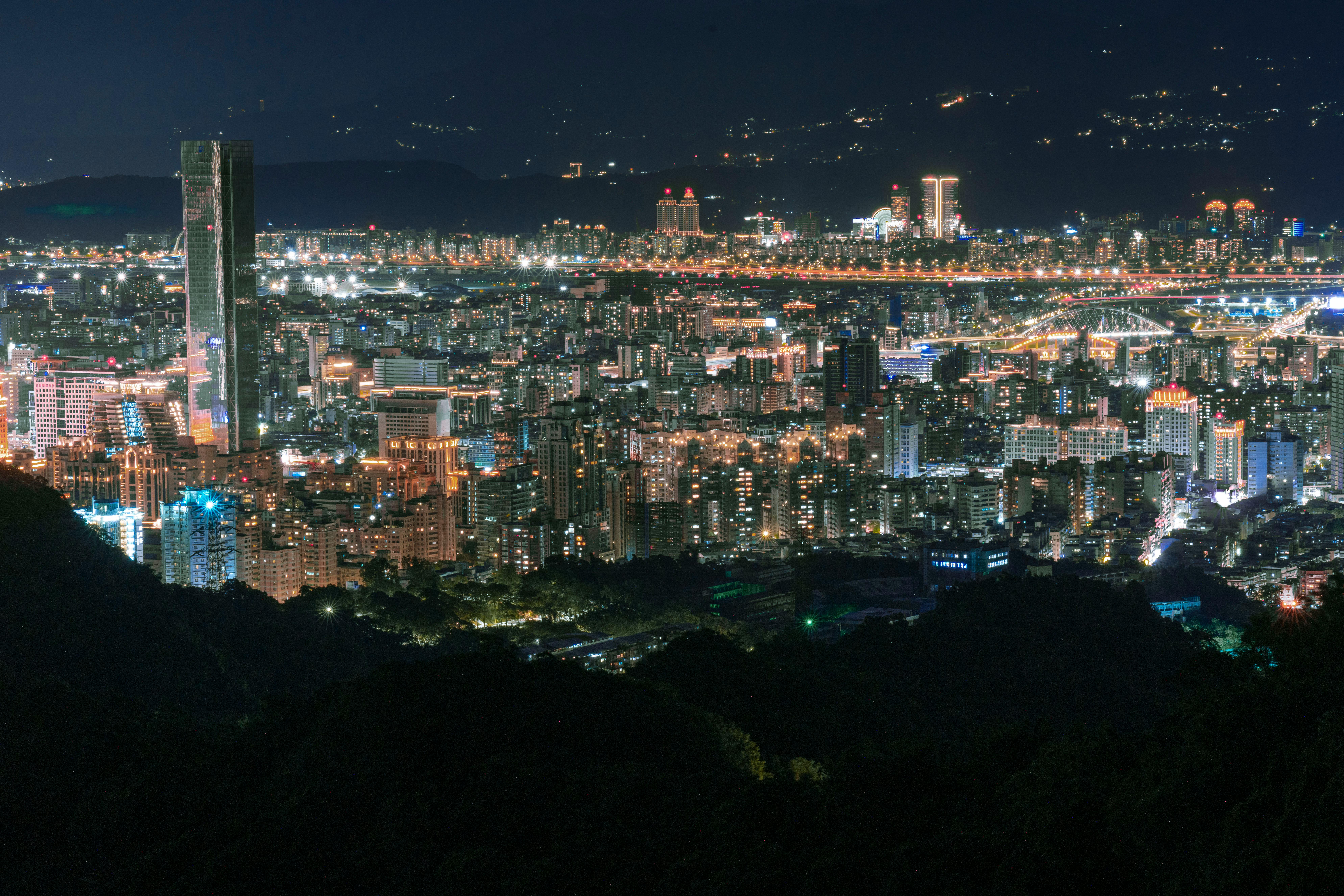 Aerial view of a bustling city lit up at night showcasing towering skyscrapers and vibrant lights.