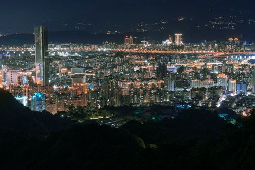 Free Aerial view of a bustling city lit up at night showcasing towering skyscrapers and vibrant lights. Stock Photo