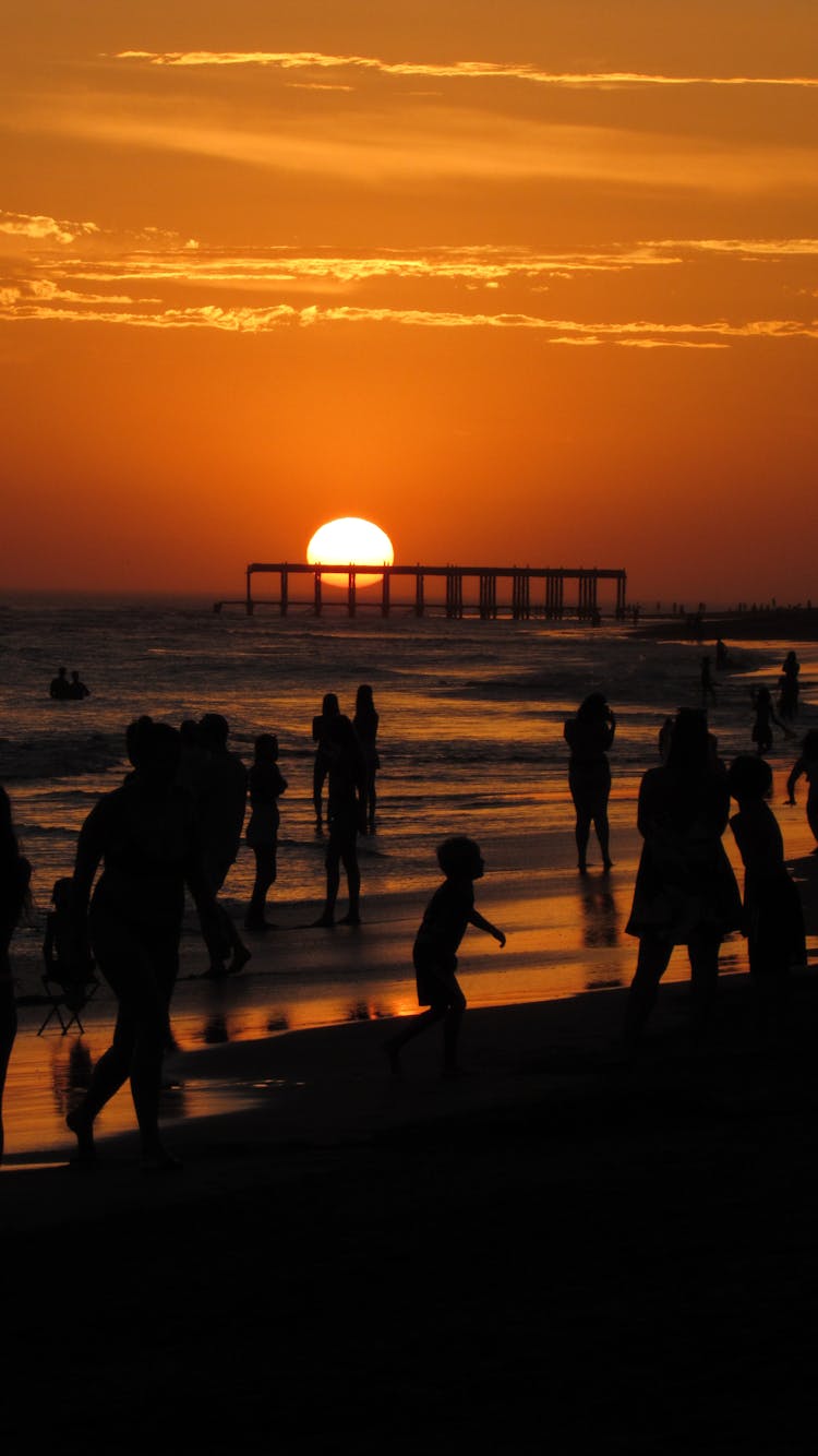 A Silhouette Of People At A Beach