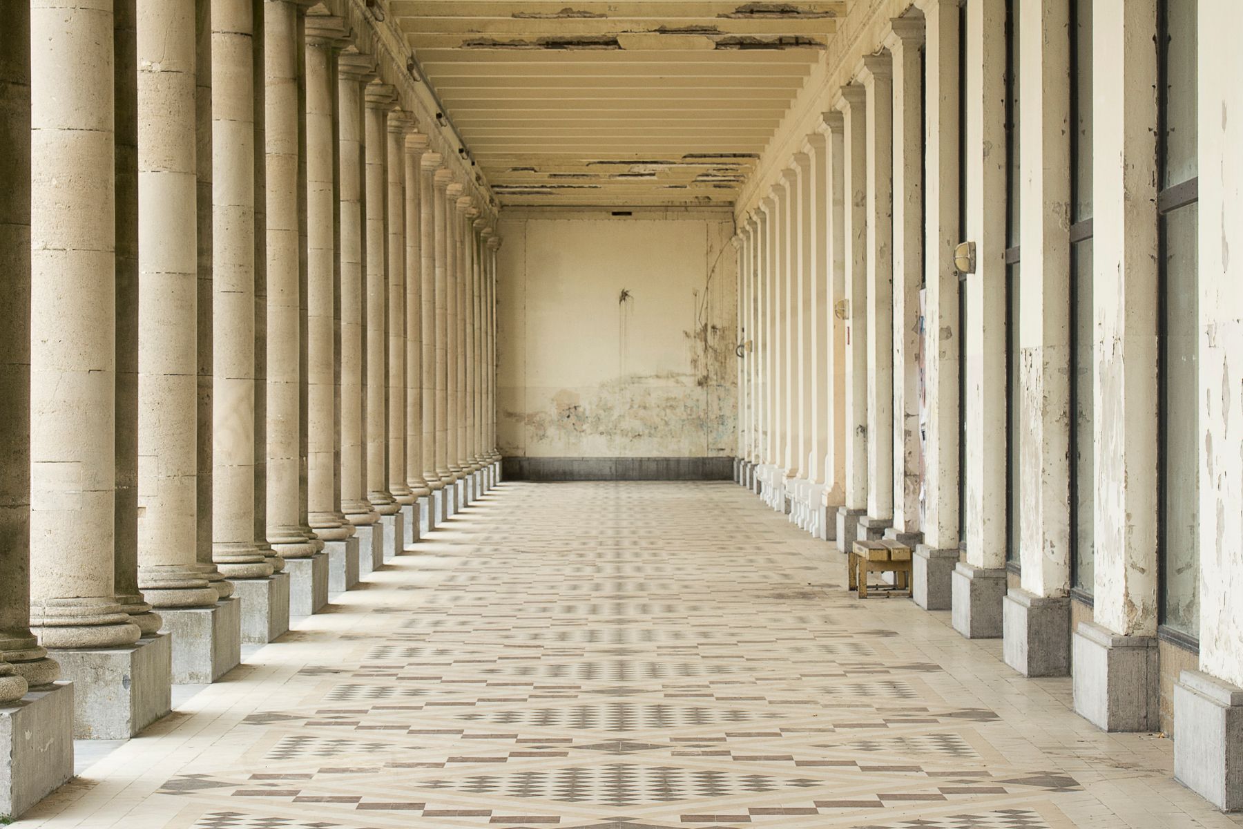 A long colonnade of stone columns receding into the distance