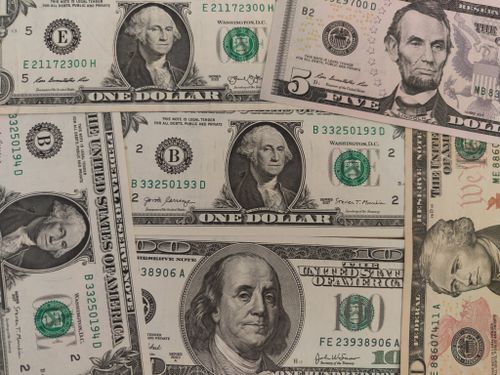 Free Close-up image showing a mix of U.S. dollar bills including $1, $5, and $10 bills. Stock Photo