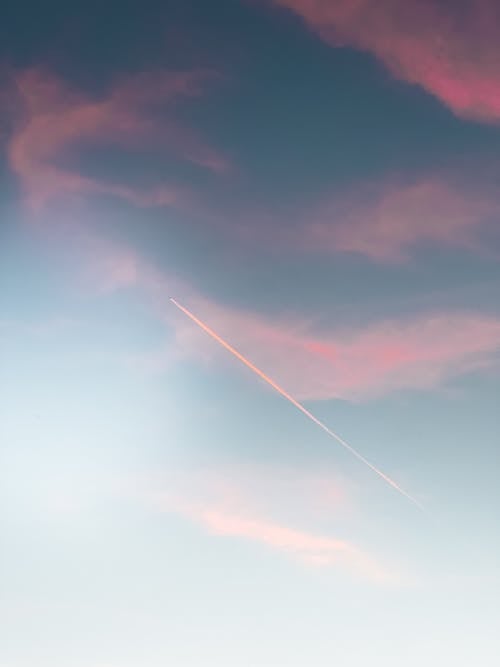 Clouds and Contrail on Sky at Dusk