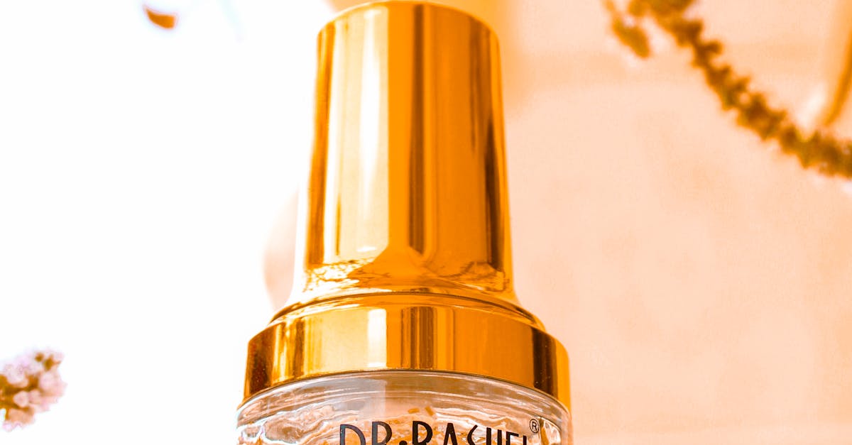 A close-up photo of a bottle of hyaluronic acid serum with water droplets on it.