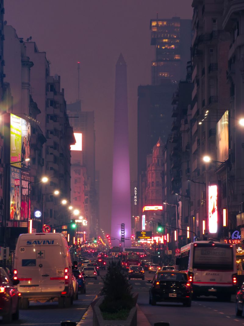 The Obelisco de Buenos Aires rising above Avenida 9 de Julio at dusk