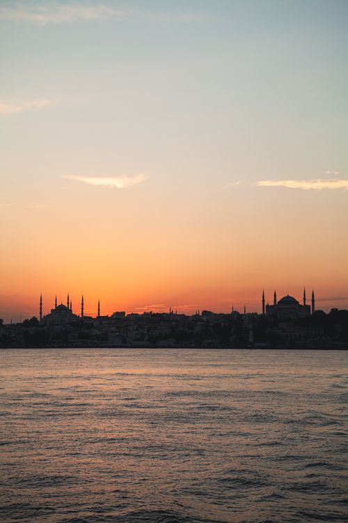 Free Silhouette of Istanbul mosques against a vibrant sunset over the Bosphorus, Turkey. Stock Photo