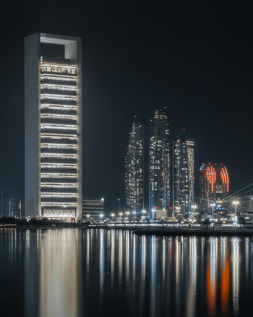 UAEThrive Daily News Roundup : Beautiful illuminated skyscrapers reflecting on the waterfront in Abu Dhabi.