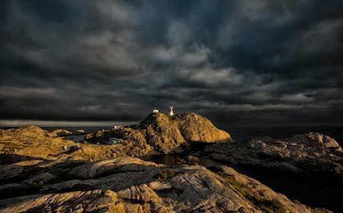 Lighthouse on the Rocks at the Coastline
