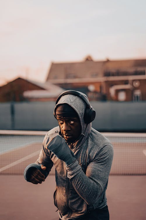 Man in Sportswear and Headphones Exercising Outdoors