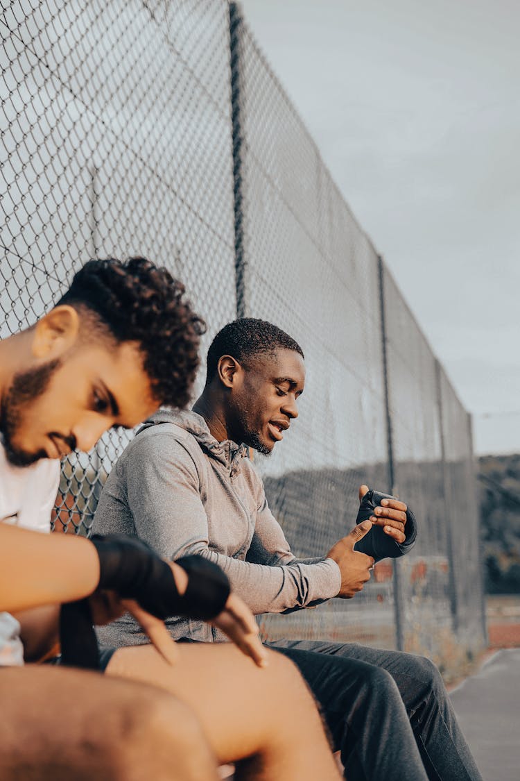 Men Putting Bandages On Their Hands