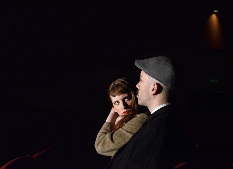 Redhead Woman With Red Lipstick And Man In A Hat At Night