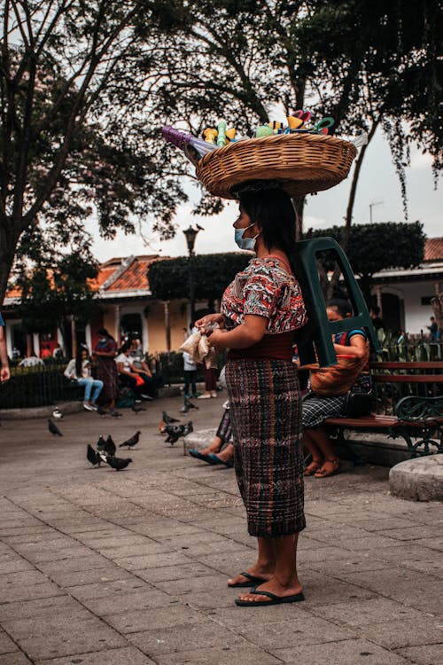 Female Street Vendor carrying Woven Tray on her Head