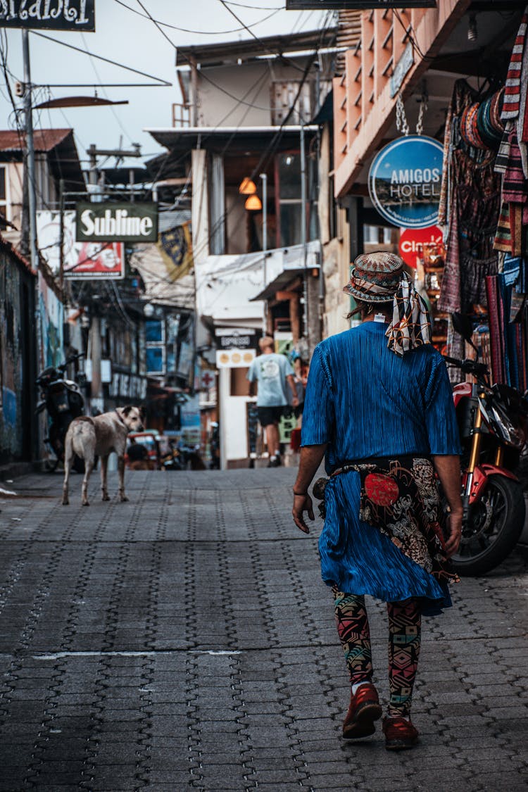 Backview Of Person Walking Near Shops 