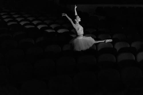 Grayscale Photo of a Dancing Woman