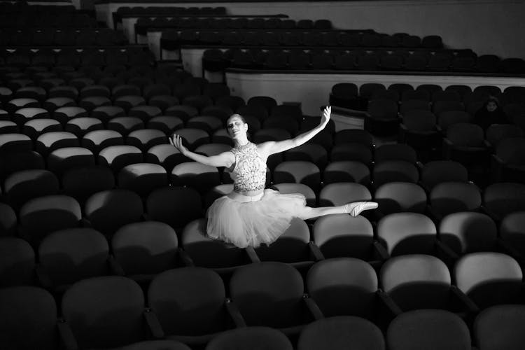 Monochrome Photo Of A Ballerina In An Empty Theatre 