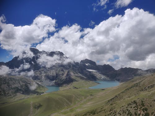 Rocky Mountains and Terrains under Cloudy Sky 