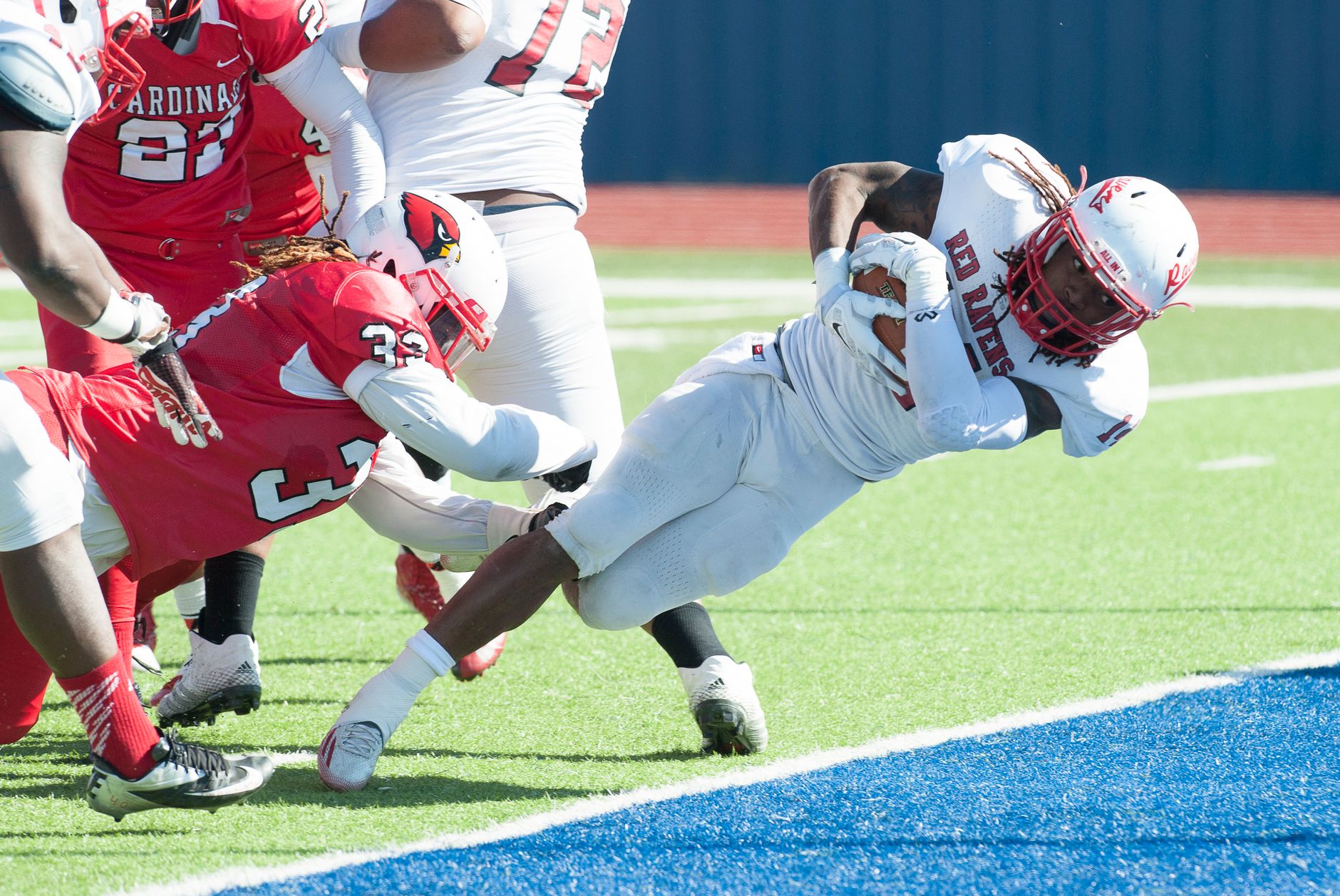 Dynamic scene of American football players in an intense play on the field.