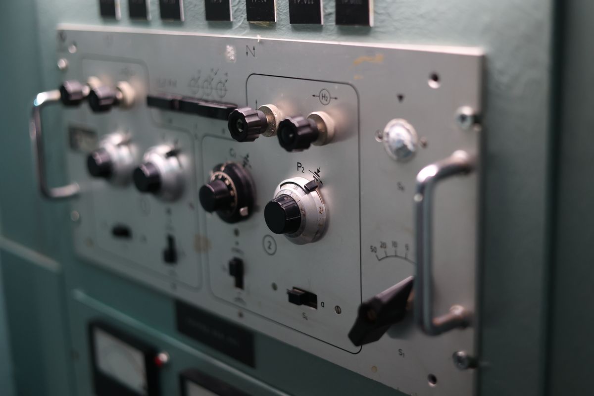 Switches and dials on an industrial control panel used by operators who issue and receive Operating Instructions
