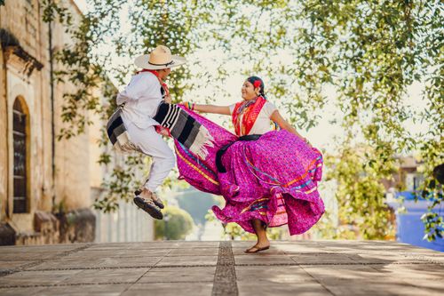 Free A colorful tradition unfolds with dancers in vibrant attire celebrating in the streets of Oaxaca, Mexico. Stock Photo