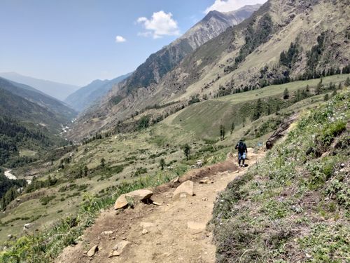 Free Explore stunning mountain trails with a solo hiker in a lush summer landscape. Stock Photo