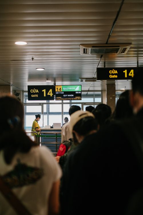 Free People standing in line at an airport gate, waiting to board a flight. Stock Photo