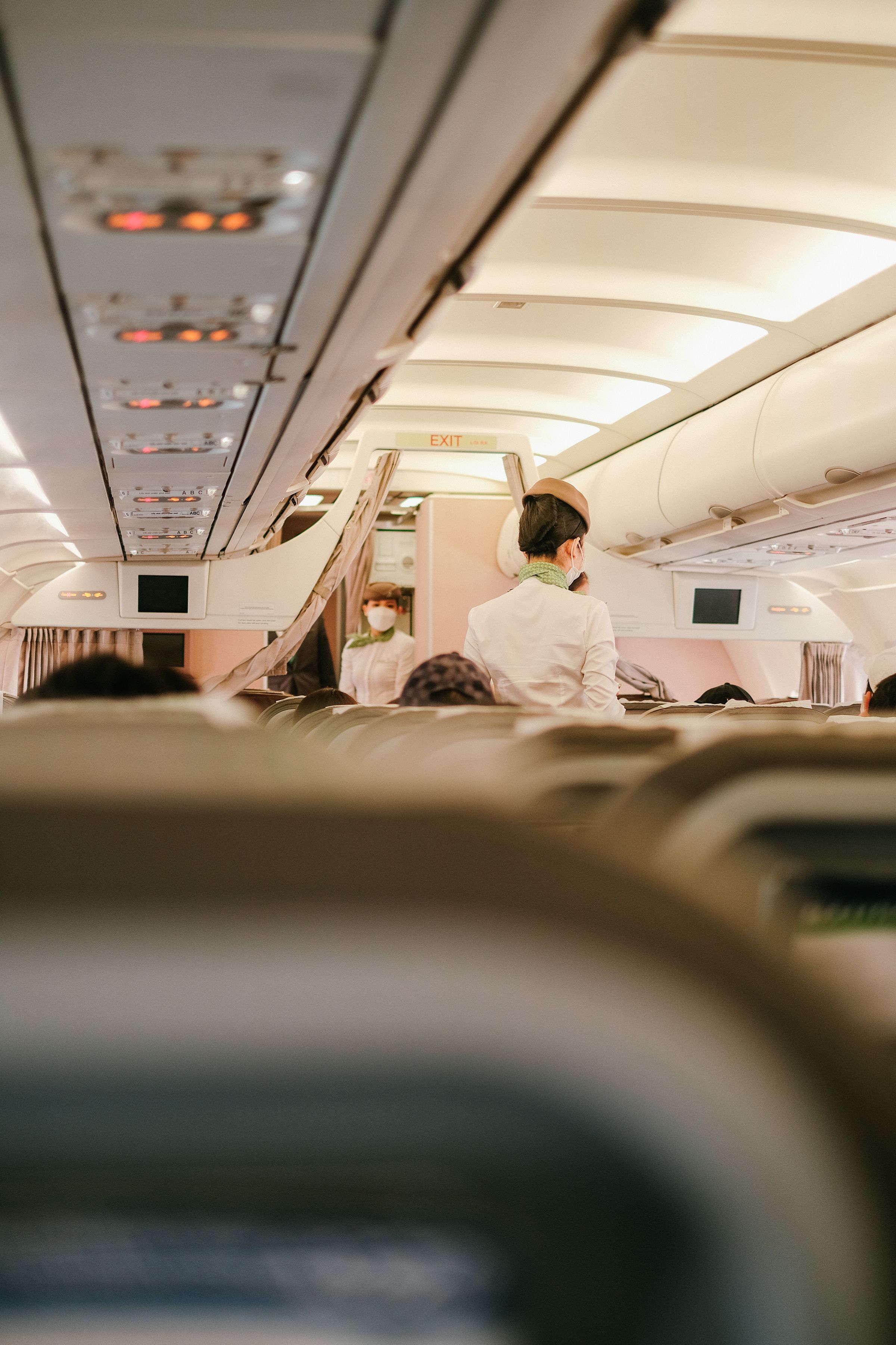 Professional flight attendant inside aircraft cabin