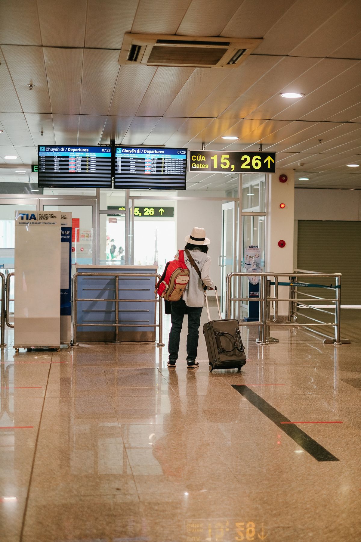 Woman waiting at the airport terminal in an easy layered travel look Woman waiting at the airport terminal in an easy layered travel look