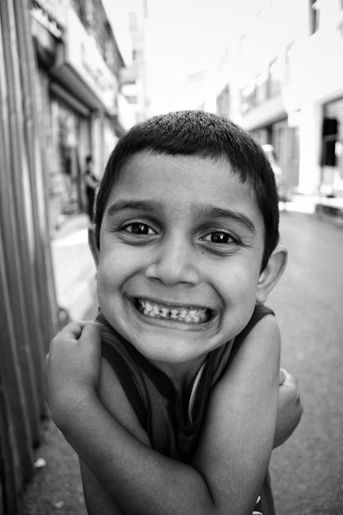 Grayscale Photo of Smiling Boy