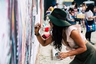 Photo of Woman Painting on Wall