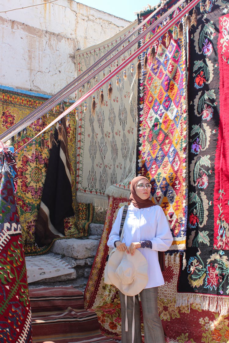 Woman In Venue Decorated With Rugs