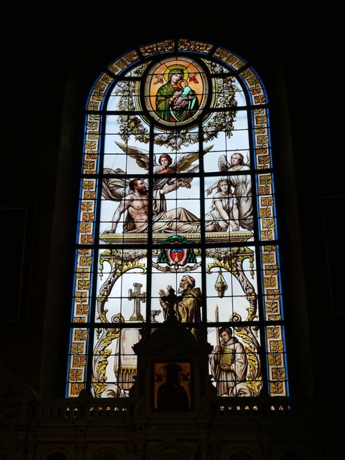 Free Intricate stained glass window depicting biblical scenes in an ancient cathedral. Stock Photo