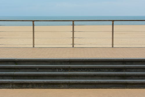 Platform with Stairs and Metal Railing on Beach Shore
