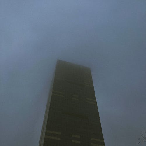 High Rise Concrete Building Under Foggy Gray Sky