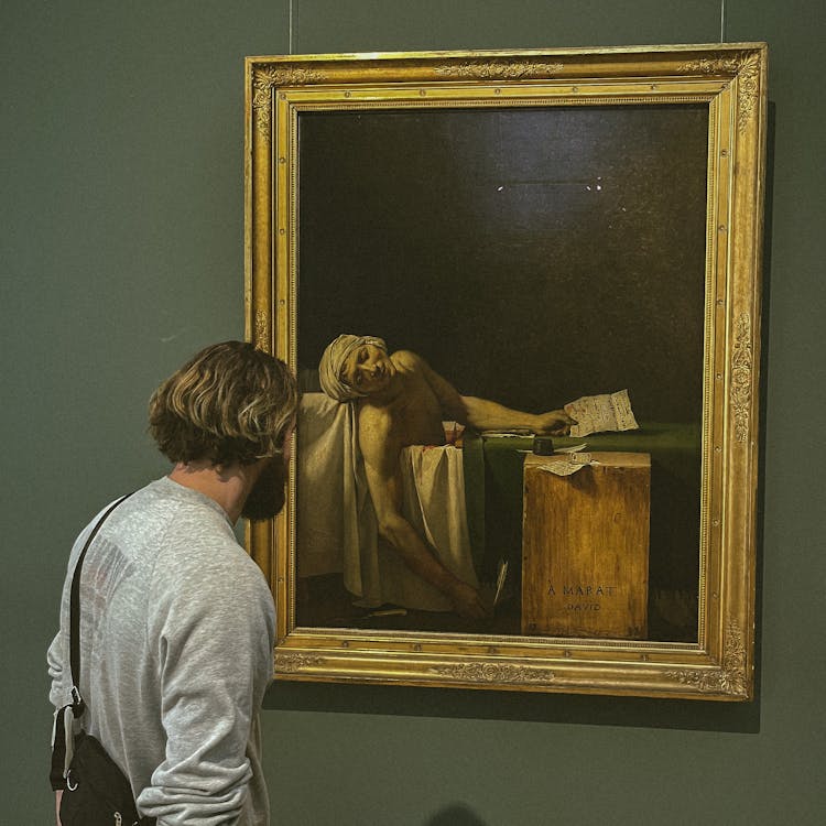 Man Looking At A Painting