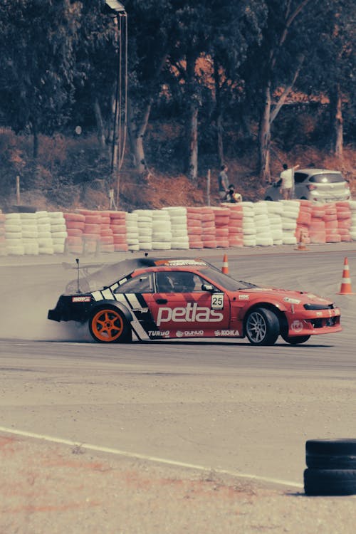 Red and Black Racing Car on Track