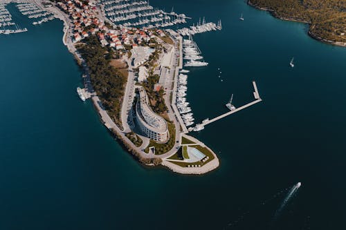 Aerial View of Boats Docked Along a Building on an Island