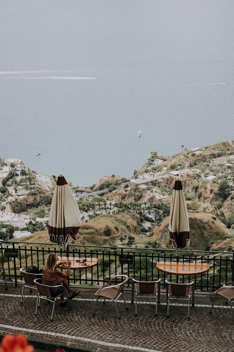 Restaurant Tables On The Patio With A View Of Sea And Coastline 