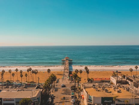 Stunning aerial photo of Manhattan Beach Pier extending into the Pacific Ocean, California.