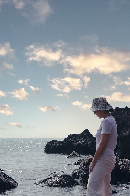 A Woman Wearing a Bucket Hat at the Beach