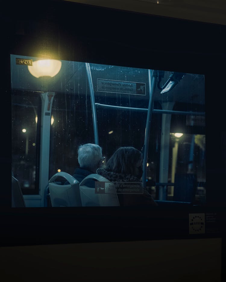 A Man And A Woman Riding A Bus