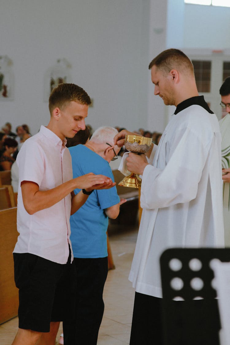 A Man Receiving The Holy Communion