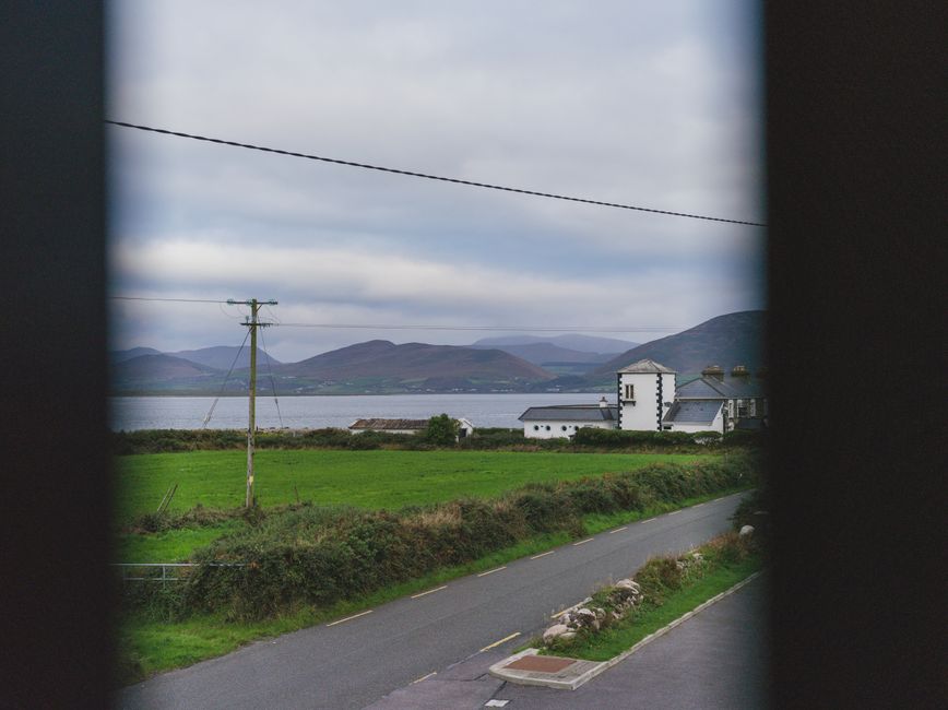 An Irish Rail train traveling through the picturesque green countryside of Ireland