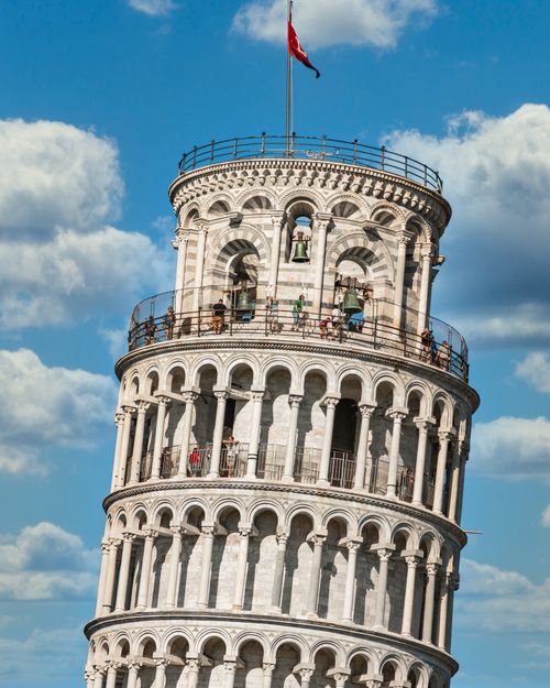 Free Close-up of the famous Leaning Tower of Pisa, Italy, with people visible on a sunny day. Stock Photo