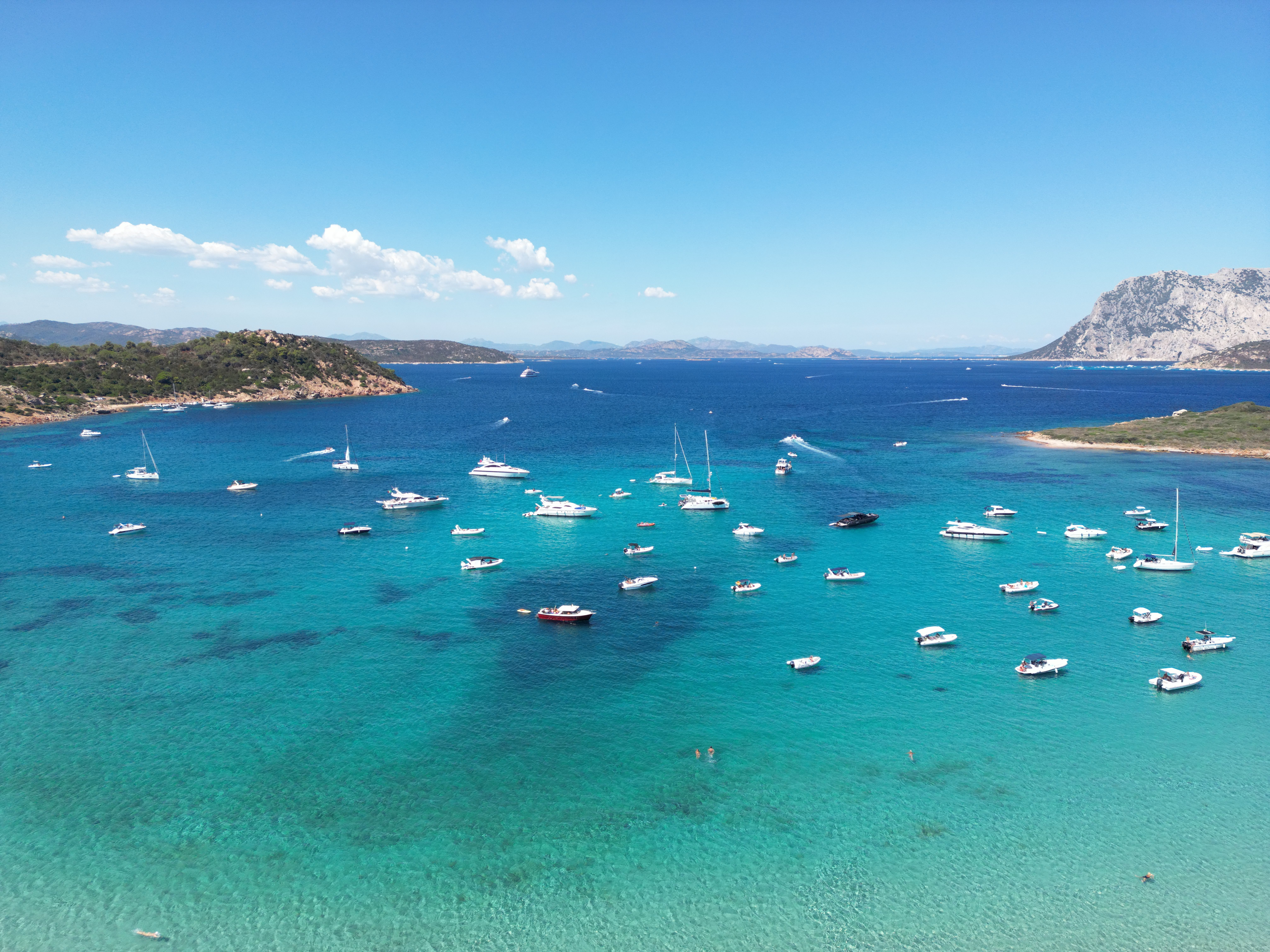 Unforgettable Yacht Tour in the Gulf of Cagliari with Aperitif Review: A Sardinian Sailing Experience Worth Every Euro Review 2026 - Stunning aerial view of boats on the clear waters of San Teodoro, Sardinia.