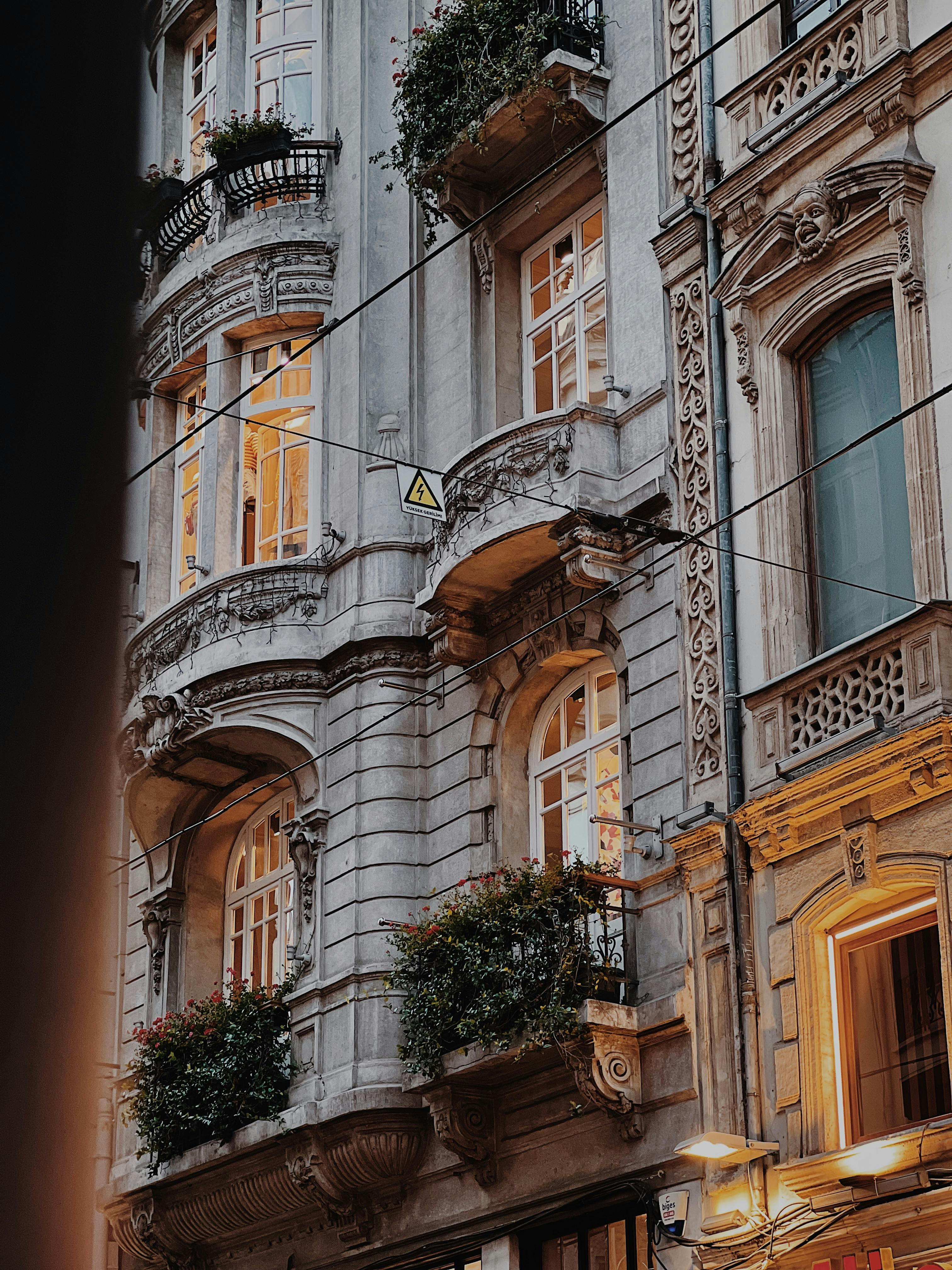 Elegant historical building facade with balconies and plants in Istanbul, Turkey.