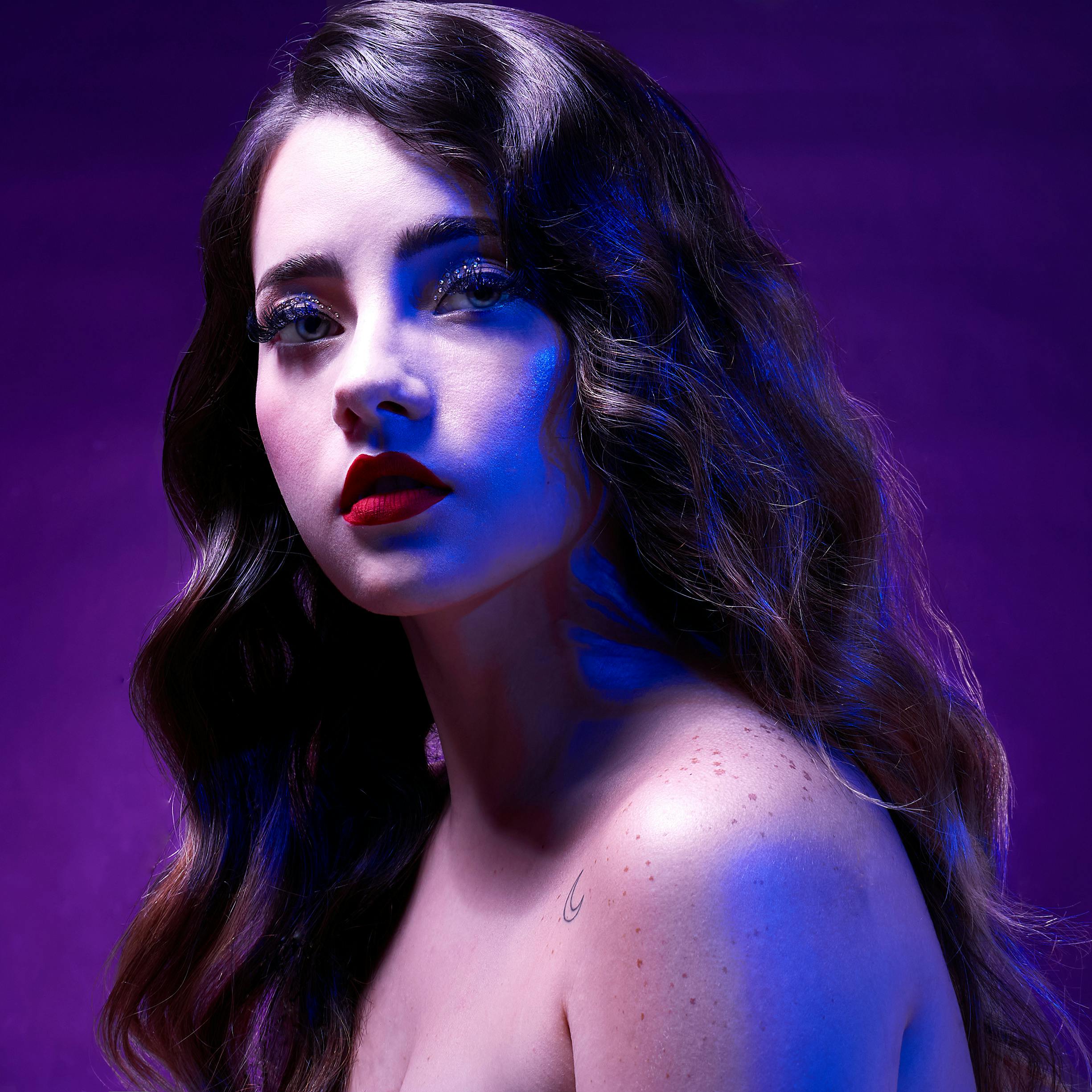 Nightclub atmosphere with neon purple lights and dark editorial mood