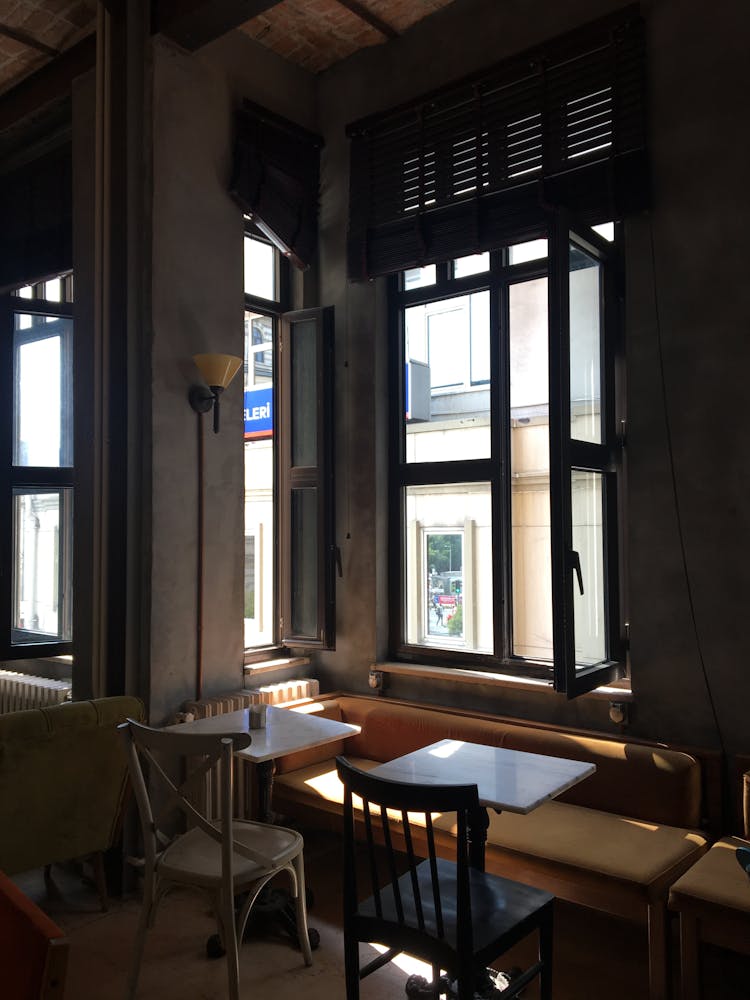 Empty Table And Chairs Beside A Window 