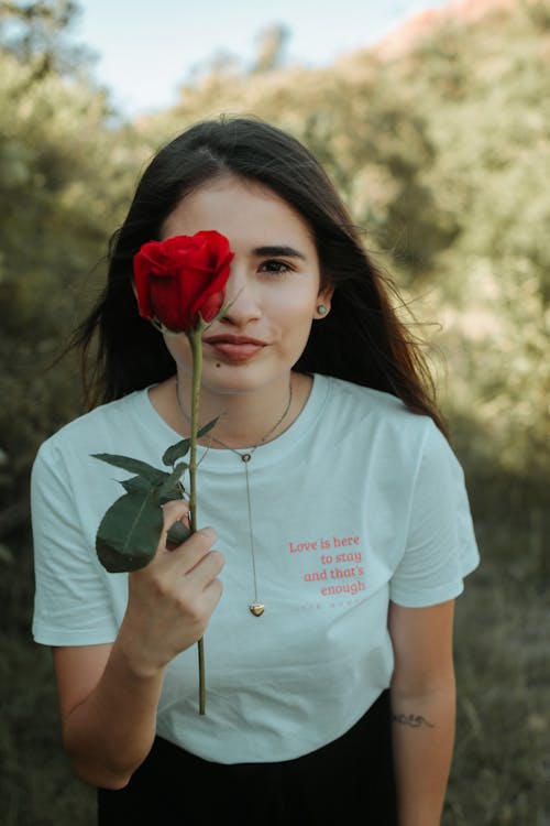 A Woman Holding a Flower 