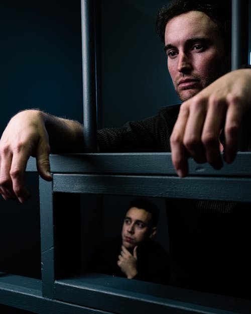 Free Two Men Behind Bars  Stock Photo