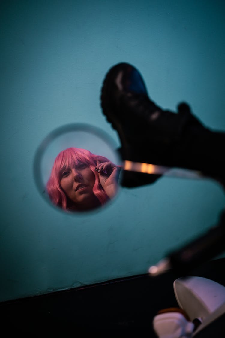 Reflection Of Woman With Pink Hair On A Mirror 